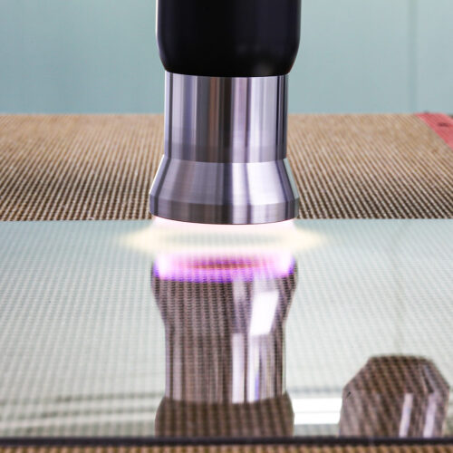 plasma etching tool processing glass with purple glow
