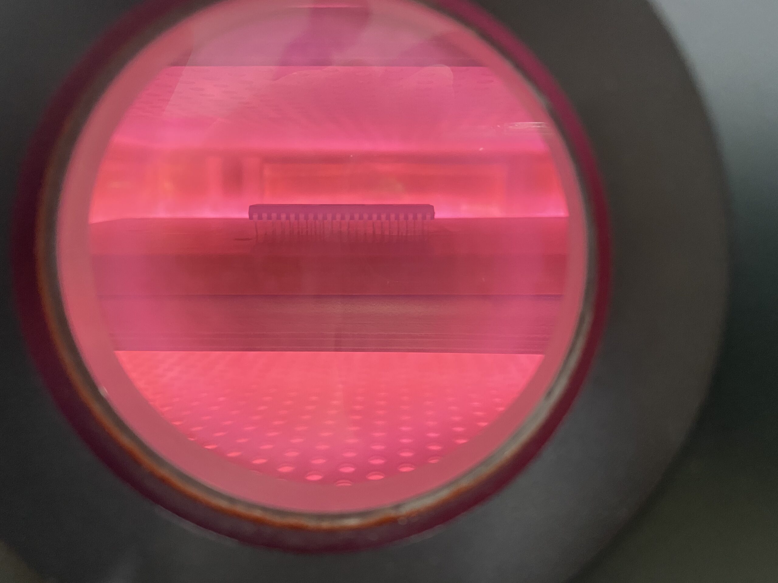 Semiconductor package undergoing vacuum plasma cleaning in a chamber